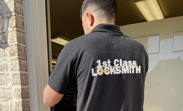1st Class Locksmith technician adjusting a door and strike plate