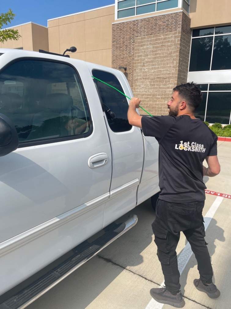 Dallas Locksmith tech unlocking a vehicle in Dallas TX.