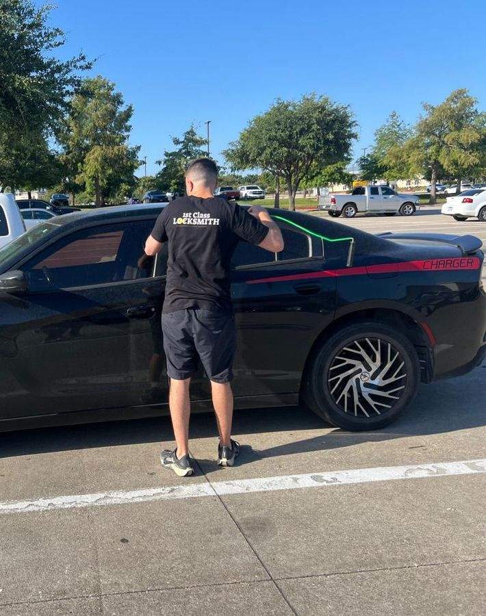 Locksmith making a replacement car key on-site in Frisco TX