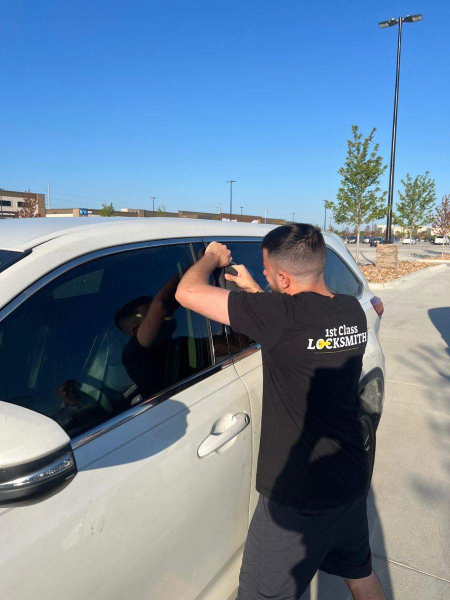 1st Class Locksmith technician opening a locked car door in Frisco TX