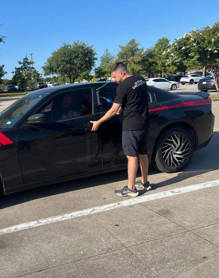Technician programming a car key fob in Frisco TX